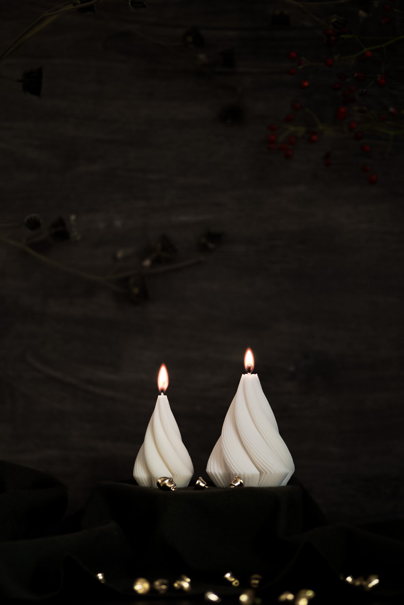 Two handcrafted Christmas candles in a twisting design, made from eco-friendly European rapeseed wax by noosh.studio. Displayed on a dark background with gold holiday accents, perfect for festive home decor or gifting during the Christmas season.